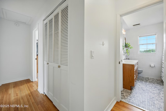276 Baisden Rd, Jacksonville, FL 32218 - hallway with light wood-style floors, a sink, and baseboards