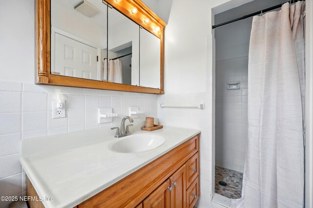 276 Baisden Rd, Jacksonville, FL 32218 - bathroom featuring a tile shower, vanity, tasteful backsplash, and tile walls