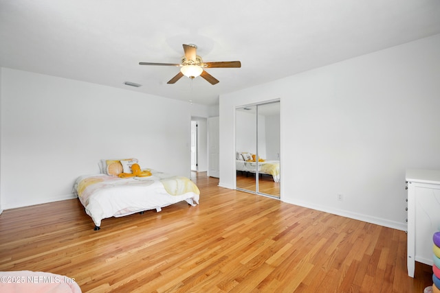 276 Baisden Rd, Jacksonville, FL 32218 - bedroom featuring light wood-type flooring, a closet, a ceiling fan, and baseboards