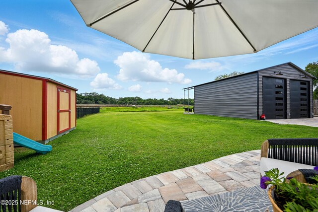 276 Baisden Rd, Jacksonville, FL 32218 - view of green lawn with an outbuilding