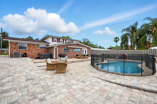 276 Baisden Rd, Jacksonville, FL 32218 - view of swimming pool with a hot tub, a patio area, a fenced backyard, and central air condition unit