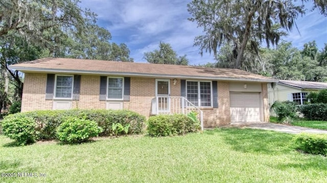 1010 N 15th St, Fernandina Beach, FL 32034 - ranch-style home featuring brick siding, an attached garage, a front lawn, and concrete driveway