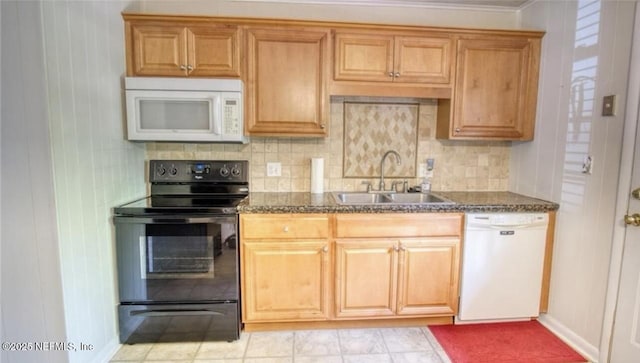 1010 N 15th St, Fernandina Beach, FL 32034 - kitchen featuring white appliances, a sink, backsplash, dark stone countertops, and crown molding