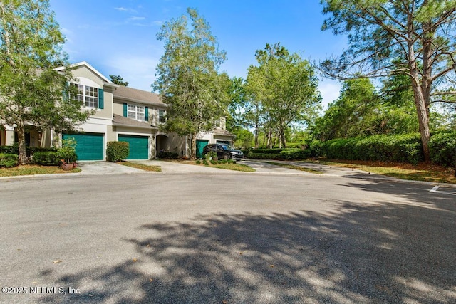 7990 Baymeadows Rd E Unit 2006, Jacksonville, FL 32256 - view of front of house with an attached garage, driveway, and stucco siding