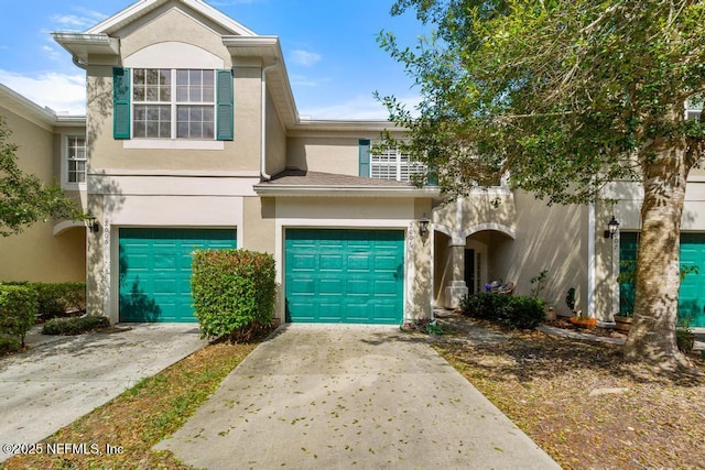 7990 Baymeadows Rd E Unit 2006, Jacksonville, FL 32256 - townhome / multi-family property with stucco siding, concrete driveway, and an attached garage
