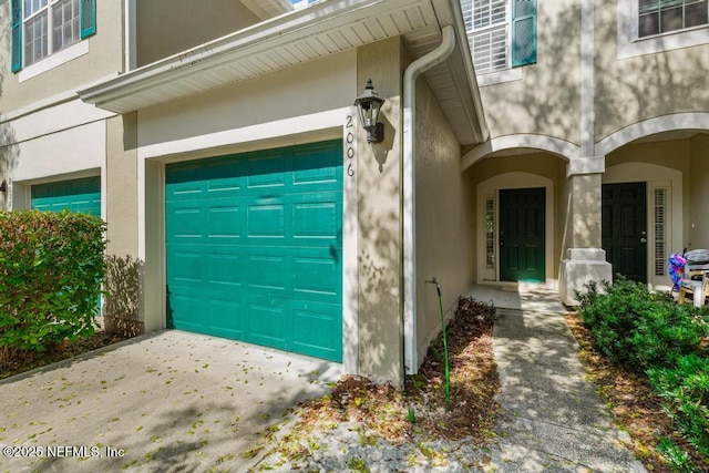7990 Baymeadows Rd E Unit 2006, Jacksonville, FL 32256 - entrance to property with stucco siding, driveway, and a garage