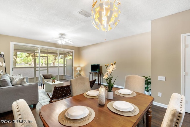 7990 Baymeadows Rd E Unit 2006, Jacksonville, FL 32256 - dining space featuring dark wood-style floors, ceiling fan, baseboards, a chandelier, and a textured ceiling