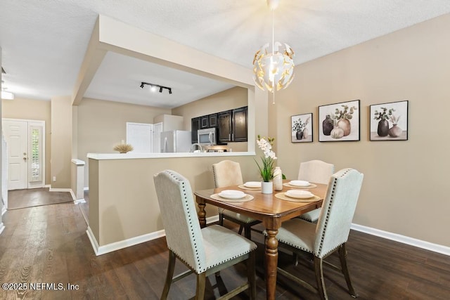 7990 Baymeadows Rd E Unit 2006, Jacksonville, FL 32256 - dining room with baseboards, dark wood finished floors, and a chandelier
