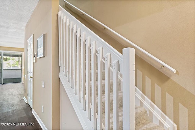 7990 Baymeadows Rd E Unit 2006, Jacksonville, FL 32256 - stairs with wood finished floors, a textured ceiling, and baseboards