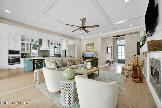 71 Deer Ridge Dr, Ponte Vedra, FL 32081 - living area featuring coffered ceiling, a tiled fireplace, ceiling fan, light wood-type flooring, and recessed lighting