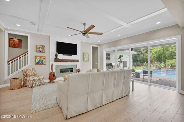 71 Deer Ridge Dr, Ponte Vedra, FL 32081 - living area featuring coffered ceiling, light wood-style floors, baseboards, a ceiling fan, and a glass covered fireplace