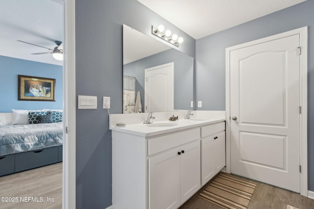 2309 Shady Breeze Ln, Green Cove Springs, FL 32043 - ensuite bathroom with double vanity, wood finished floors, and ceiling fan