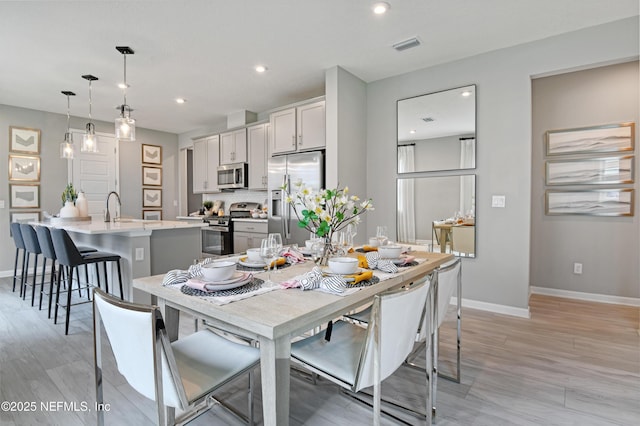 95 Elm Creek Dr, Saint Augustine, FL 32092 - dining room featuring baseboards, light wood-type flooring, and recessed lighting
