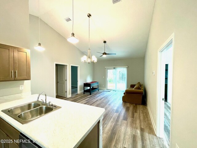 1303 Bonaventure Ave, Green Cove Springs, FL 32043 - kitchen with a sink, wood finished floors, high vaulted ceiling, light countertops, and open floor plan