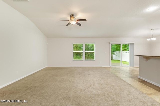 112 Glenlivet Way, Saint Johns, FL 32259 - unfurnished living room featuring a ceiling fan, light carpet, a chandelier, light tile patterned flooring, and vaulted ceiling