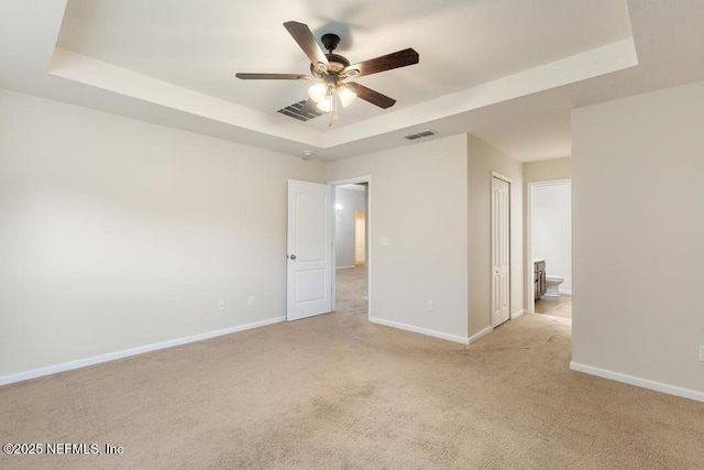 112 Glenlivet Way, Saint Johns, FL 32259 - unfurnished bedroom featuring a raised ceiling, light carpet, ceiling fan, and ensuite bath