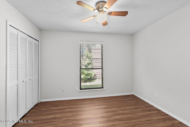 5524 Manfields Pl, Jacksonville, FL 32207 - unfurnished bedroom featuring multiple windows, a closet, wood finished floors, baseboards, and a textured ceiling