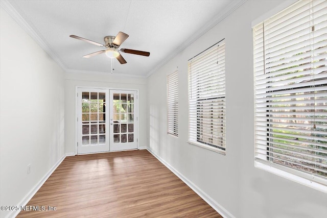 5524 Manfields Pl, Jacksonville, FL 32207 - empty room with wood finished floors, french doors, ceiling fan, crown molding, and baseboards