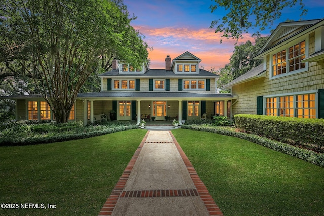 145 River Rd, Orange Park, FL 32073 - shingle-style home featuring a porch, a yard, a chimney, and french doors