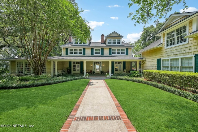 145 River Rd, Orange Park, FL 32073 - view of front of house featuring a front lawn, a chimney, a porch, and french doors