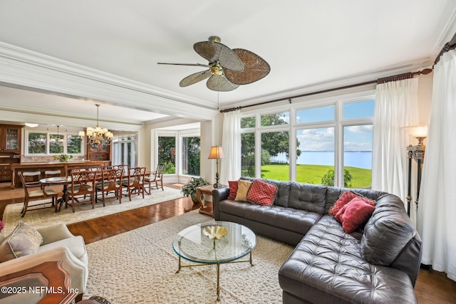 145 River Rd, Orange Park, FL 32073 - living area featuring wood finished floors, crown molding, ceiling fan, healthy amount of natural light, and a chandelier