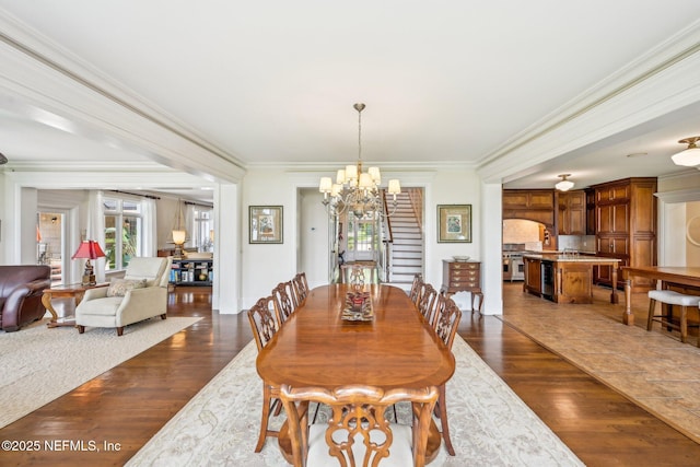 145 River Rd, Orange Park, FL 32073 - dining room with dark wood finished floors, a chandelier, ornamental molding, and stairway