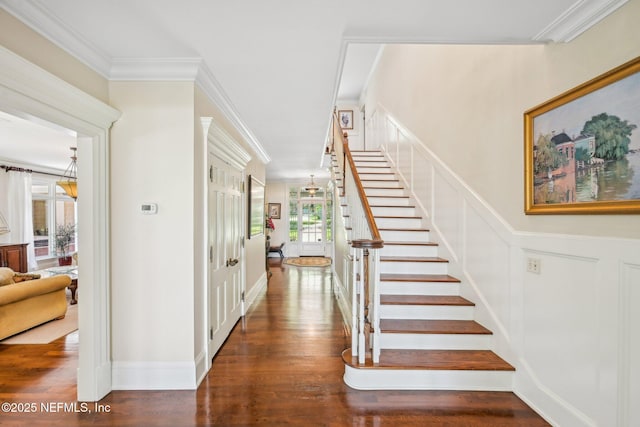 145 River Rd, Orange Park, FL 32073 - stairway featuring wood finished floors, ornamental molding, a decorative wall, and wainscoting