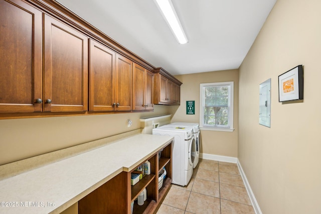 145 River Rd, Orange Park, FL 32073 - laundry area featuring cabinet space, washing machine and clothes dryer, light tile patterned flooring, baseboards, and electric panel