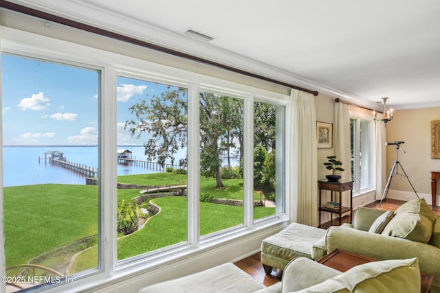 145 River Rd, Orange Park, FL 32073 - living room with a water view, plenty of natural light, crown molding, a chandelier, and baseboards