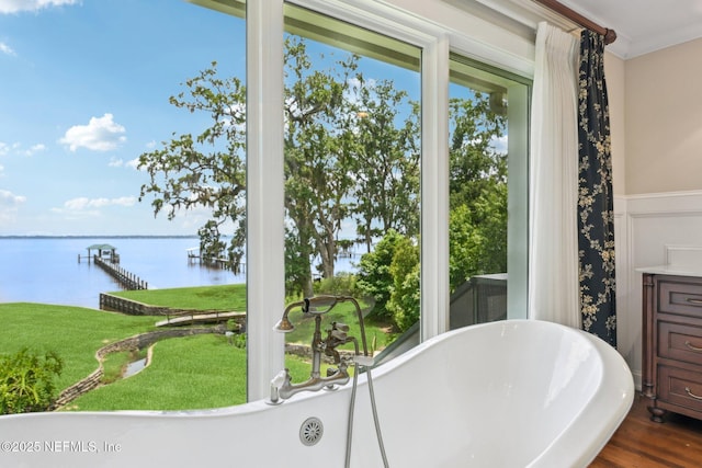 145 River Rd, Orange Park, FL 32073 - full bathroom with a water view, a freestanding bath, wainscoting, crown molding, and wood finished floors