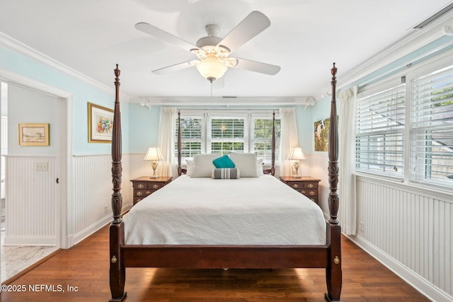 145 River Rd, Orange Park, FL 32073 - bedroom with wainscoting, wood finished floors, crown molding, and ceiling fan