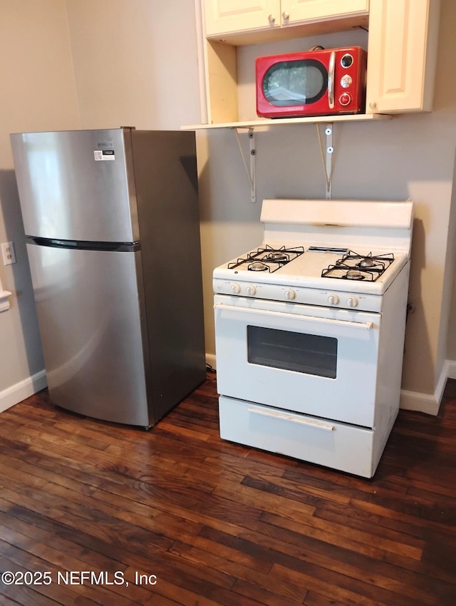 3238 Green St, Jacksonville, FL 32205 - kitchen with freestanding refrigerator, white gas range oven, and dark wood-type flooring