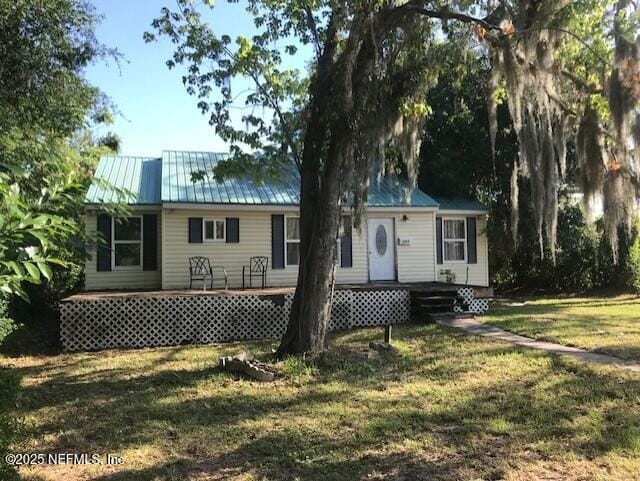2404 Crill Ave, Palatka, FL 32177 - back of house with a lawn and metal roof