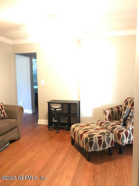 2404 Crill Ave, Palatka, FL 32177 - living room featuring ornamental molding, wood finished floors, and baseboards