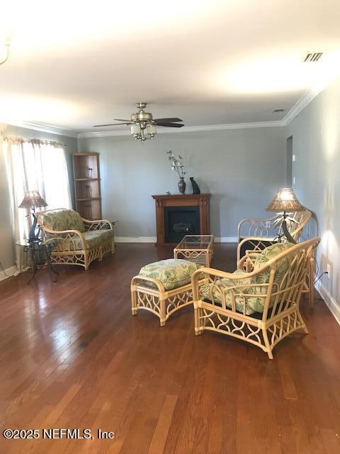 2404 Crill Ave, Palatka, FL 32177 - sitting room with crown molding, wood finished floors, baseboards, and a ceiling fan