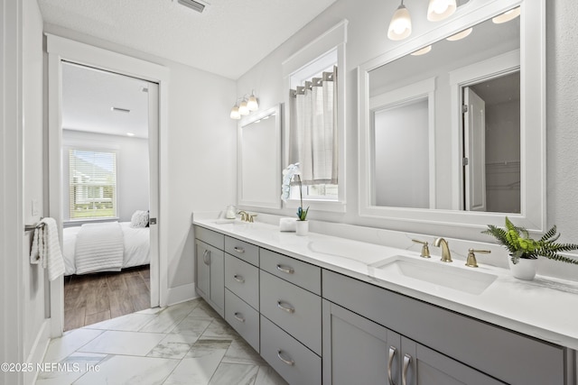 85 Park Center Ave, Ponte Vedra, FL 32081 - ensuite bathroom featuring double vanity, marble look tile flooring, and baseboards