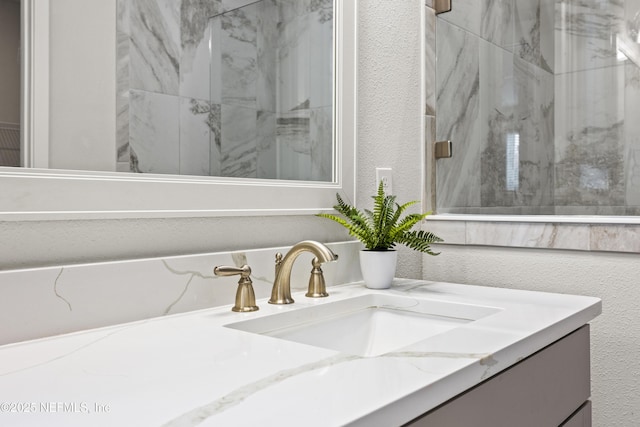 85 Park Center Ave, Ponte Vedra, FL 32081 - bathroom with vanity, a textured wall, and a marble finish shower