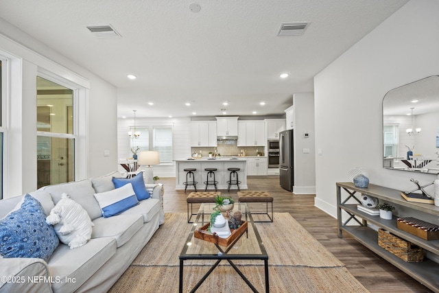 85 Park Center Ave, Ponte Vedra, FL 32081 - living area with a chandelier, wood finished floors, baseboards, and recessed lighting