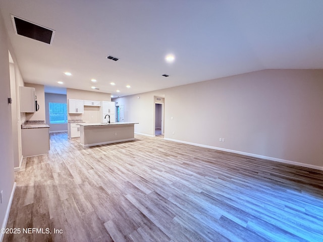 6971 Como Rd, Jacksonville, FL 32210 - unfurnished living room with a sink, light wood-type flooring, recessed lighting, and baseboards
