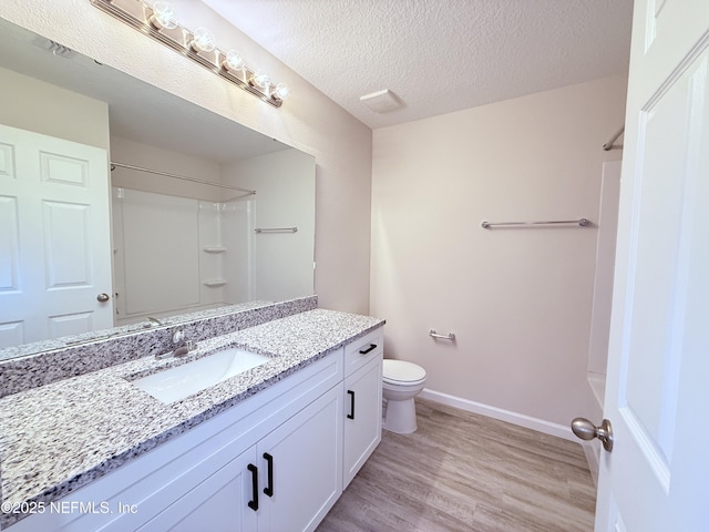 6971 Como Rd, Jacksonville, FL 32210 - bathroom featuring vanity, wood finished floors, a shower, toilet, and baseboards