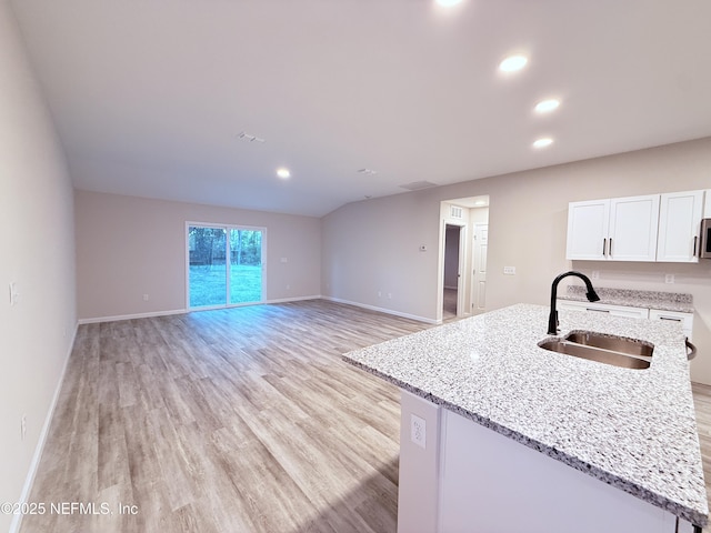 6971 Como Rd, Jacksonville, FL 32210 - kitchen with a sink, white cabinets, light wood-style floors, recessed lighting, and baseboards