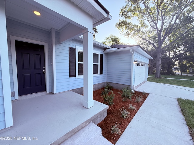 6971 Como Rd, Jacksonville, FL 32210 - entrance to property featuring a garage and concrete driveway