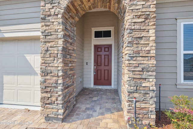 2724 White Cedar Ln, Green Cove Springs, FL 32043 - entrance to property featuring a garage and stone siding