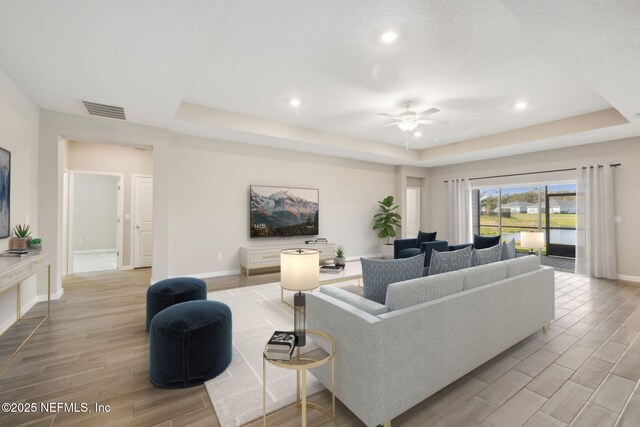 2724 White Cedar Ln, Green Cove Springs, FL 32043 - living room with a raised ceiling, wood finish floors, baseboards, ceiling fan, and recessed lighting