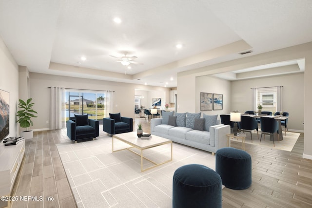 2724 White Cedar Ln, Green Cove Springs, FL 32043 - living area featuring a tray ceiling, light wood-type flooring, baseboards, recessed lighting, and ceiling fan