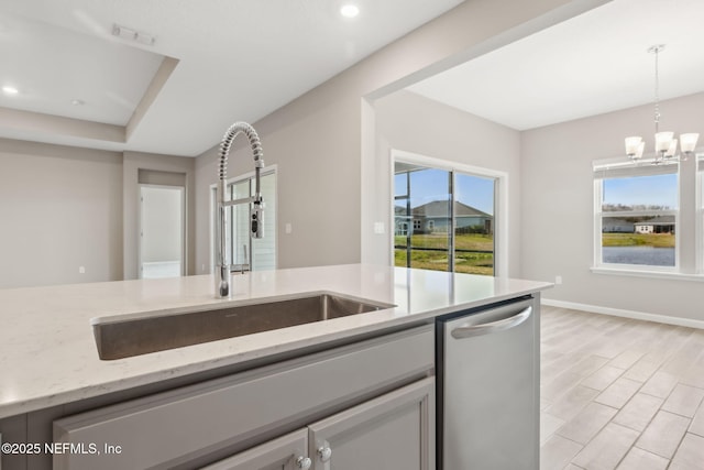 2724 White Cedar Ln, Green Cove Springs, FL 32043 - kitchen featuring dishwasher, a sink, pendant lighting, a chandelier, and light stone countertops