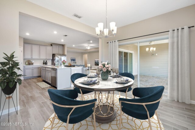 2724 White Cedar Ln, Green Cove Springs, FL 32043 - dining room featuring a chandelier, wood tiled floors, and recessed lighting