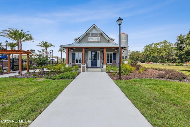 2724 White Cedar Ln, Green Cove Springs, FL 32043 - view of front facade with covered porch, a chimney, metal roof, and a pergola
