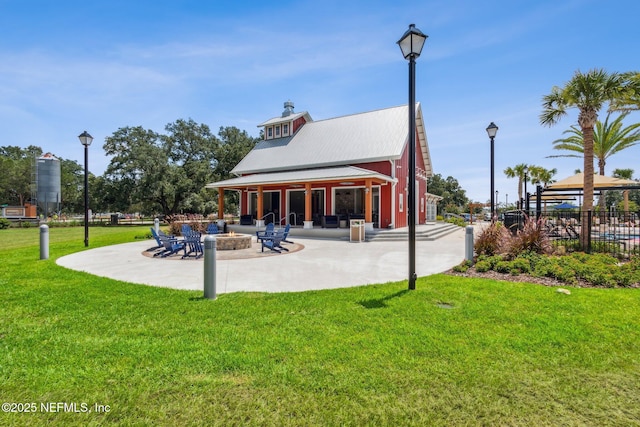 2724 White Cedar Ln, Green Cove Springs, FL 32043 - back of house with a patio, an outdoor fire pit, a lawn, metal roof, and a gazebo