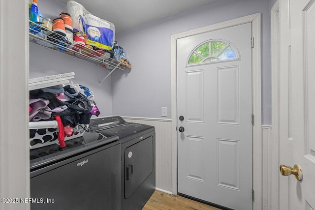 734 N Walnut St, Starke, FL 32091 - washroom featuring washing machine and dryer, wainscoting, and light wood finished floors